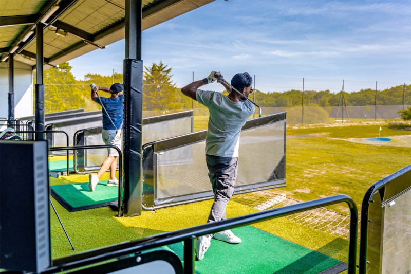 Golfer practising a swing on the green driving range at Mario's Golf Park in Paphos, Cyprus.
