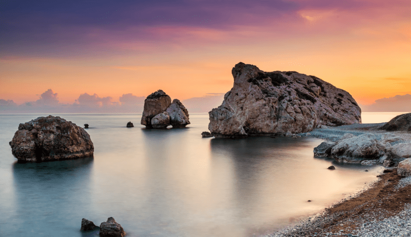 Sea stacks of Petra tou Romiou, the legendary birthplace of Aphrodite, rising from the sea at sunset along the Cyprus coast.