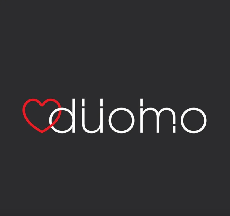 Logo of Duomo Restaurant, showing the word 'duomo' in white with a red heart on a dark background.