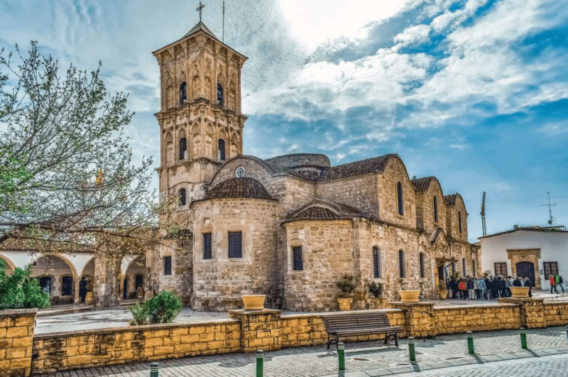 Historic stone church housing the Tomb of Saint Lazarus in Larnaca, Cyprus, under a clear sky.