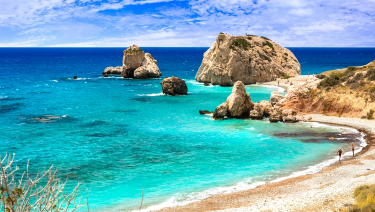 The sea stacks of Aphrodite's Rock rising from bright turquoise water along the Paphos coast in Cyprus.